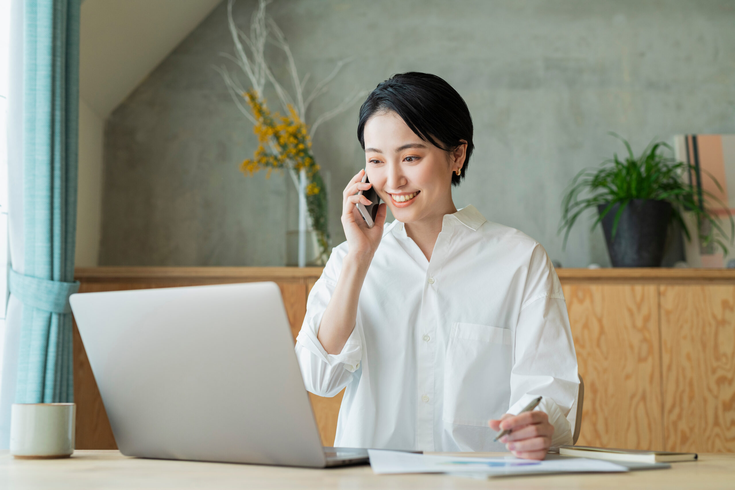 Remote Work-A remote worker on the phone and on his laptop